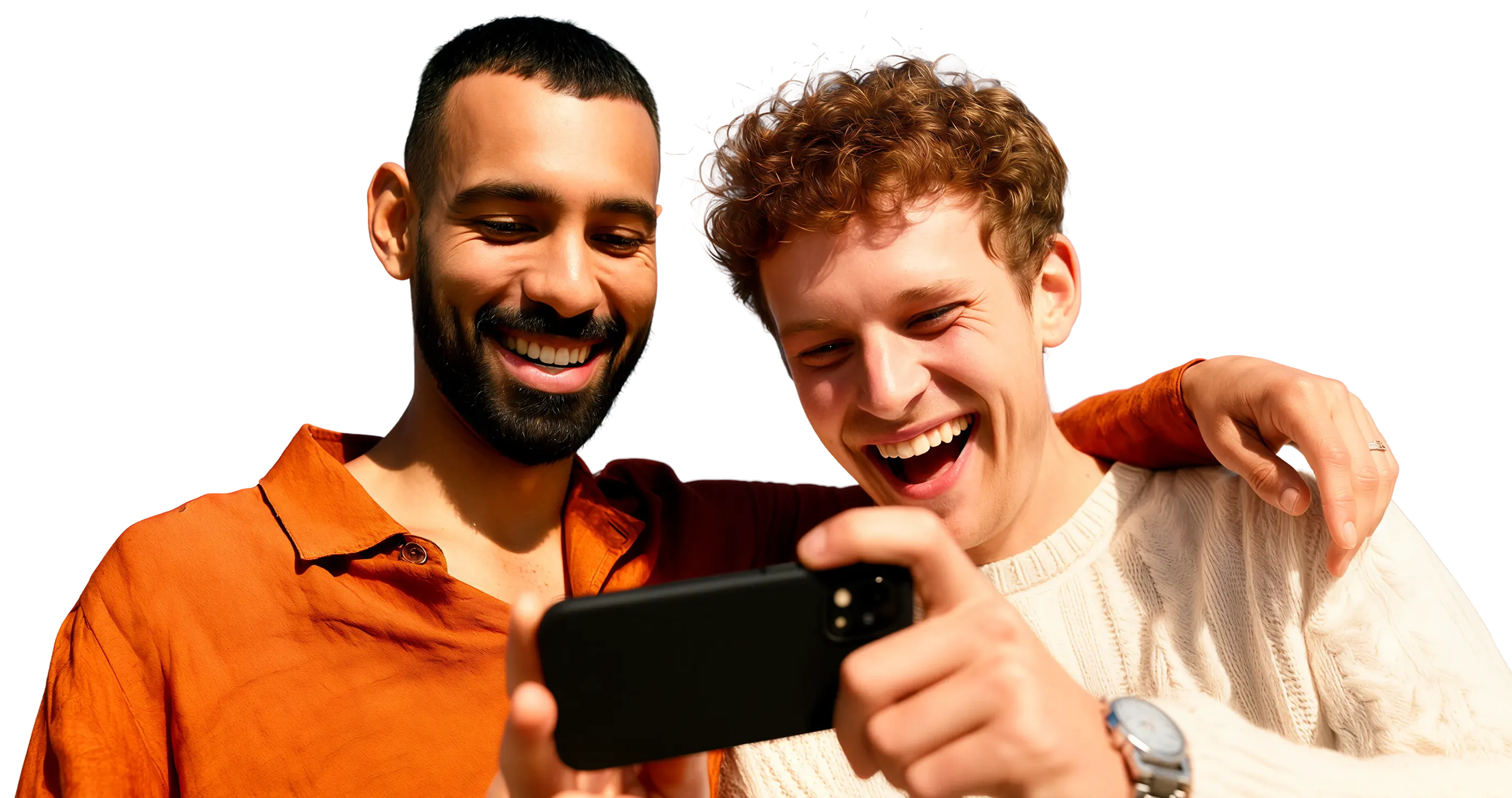 Two young men smiling and looking at a smartphone, one with arm around the other.